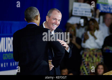 Newark, USA. 19th Oct, 2017. Former US President Barack Obama joins Phil Murphy, democratic candidate in the New Jersey gubernatorial race on stage at an October 19, 2017 campaign rally, in Newark, New Jersey. The event is the return to the political stage for Obama after leaving the White House at the end of his historic two-term precedency. Credit: Bastiaan Slabbers/Alamy Live News Stock Photo