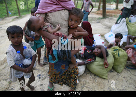 October 19, 2017 - Ukhiya, Bangladesh - Newly arrived Rohingya Muslims sit at a refugee camp in Ukhiya, Bangladesh, October 19, 2017. Thousands more Rohingya Muslims are fleeing large-scale violence and persecution in Myanmar and crossing into Bangladesh, where more than half a million others are already living in squalid and overcrowded camps, according to witnesses and a drone video shot by the U.N. office for refugees. (Credit Image: © Suvra Kanti Das via ZUMA Wire) Stock Photo