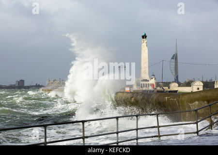 Storm Brian comes to Southsea. View looking along the Southsea beaches towards old Portsmouth. Naval war memorial and Emirates tower in the background. Two large waves breaking onto the shore Credit: David Robinson/Alamy Live News Stock Photo