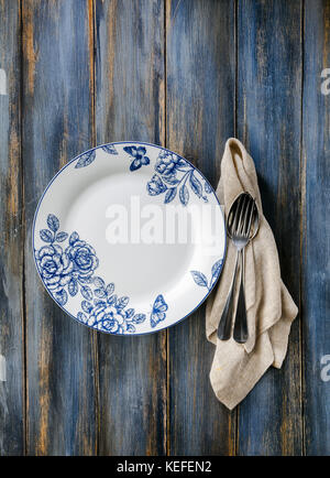 empty plate on a wooden background of old shabby boards. background for billboards, web site , use in advertising, for restaurants and cafes Stock Photo