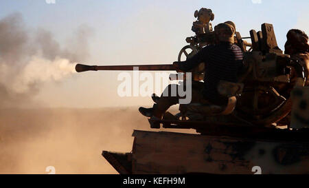 Still image taken from a propaganda video released October 18, 2017 showing Tahrir al-Sham in clashes against the Islamic State firing a heavy machine gun from the back of a pickup truck during battles east of Hama, Syria. HTS jihadists formed from former al-Nusra Front fighters have been fighting the Islamic State for control or the region. Stock Photo