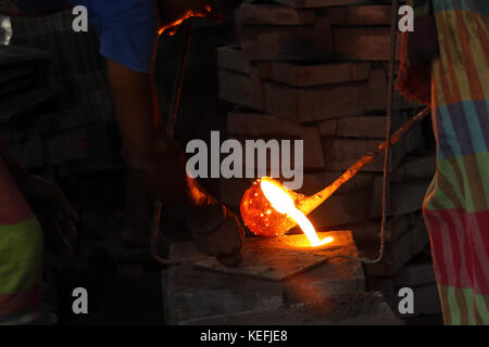 Workers in the steel re-rolling mills work without proper safety gear or tools. In these mills iron is forged in 1200 + to 1300+ Celsius. In such a he Stock Photo