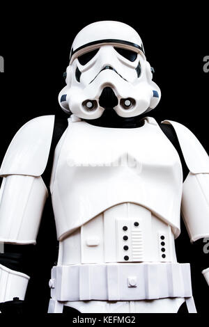 UK - July 7, 2016. A low angle view of the portrait of a Stormtrooper from the Star Wars movie franchise looking threatening on a black background. Stock Photo