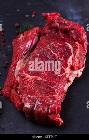 Raw beef steak close up on dark background Stock Photo