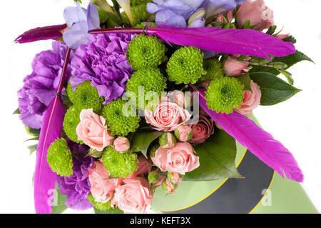 Assorted flowers with pink feathers on a white background closeup. Valentine's Day Stock Photo
