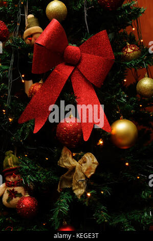 Christmas Tree Decoration with red and gold baubles and ribbon Stock Photo