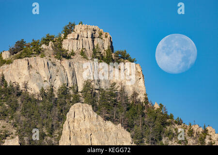 Moon setting over Sheep Mountain in the Shoshone National Forest Wyoming Stock Photo