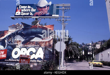 Marlboro billboard over Orca movie billboard on the Sunset Strip in Los Angeles, CA circa 1977 Stock Photo