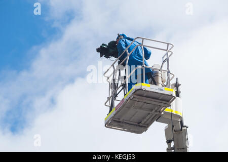 A Channel 9 camera operator films from a high vantage point in Adelaide, South Australia Stock Photo