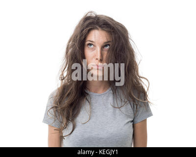 Angry young woman having a bad hair day, her long hair is messy and tangled Stock Photo