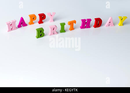The word happy birthday on a white background from multi-colored letters. Stock Photo