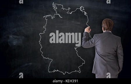 Businessman painting Germany map on blackboard concept. Stock Photo