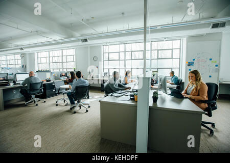 Business people working in busy office Stock Photo