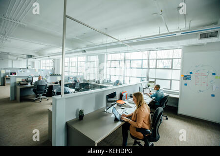 Business people working in busy office Stock Photo