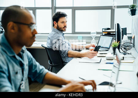 Businessmen using technology in office Stock Photo