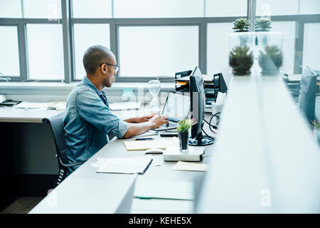 Black businessman using laptop in office Stock Photo