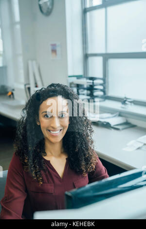 Portrait of smiling mixed race businesswoman Stock Photo
