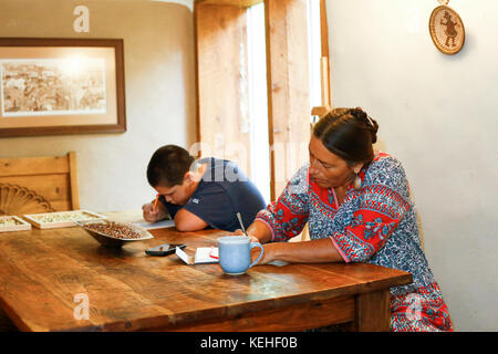 Mother and son writing at table Stock Photo