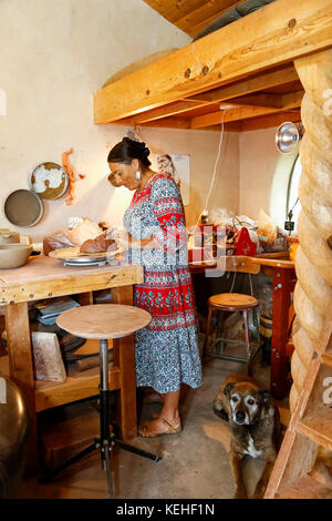 Mixed race woman shaping clay in art studio Stock Photo