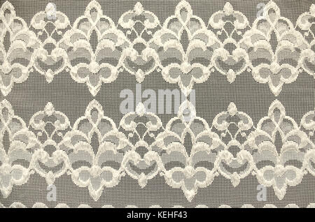 Pattern from an ornament on a thin transparent fabric stretched over a black plywood Stock Photo