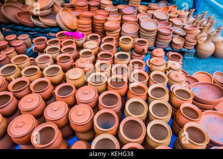 Clay pots and bowls on floor Stock Photo