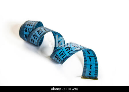 Coiled blue measure tape. Isolated on white Stock Photo