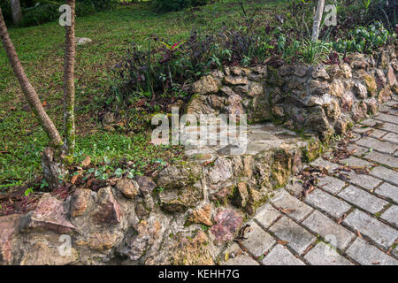 Garden ideas using natural stones for steps and garden walls Stock Photo