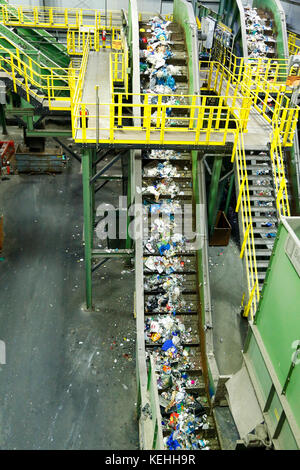 Trash on conveyor belt at factory Stock Photo