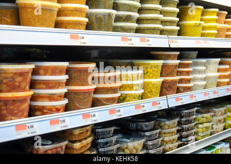 Plastic containers of food on supermarket shelves Stock Photo