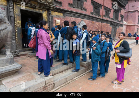 Nepalese schoolchildren in uniforms visiting Patan Museum with their teachers in Durbar Square, Kathmandu. Stock Photo