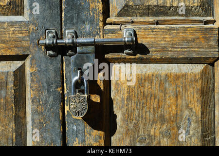 Padlock on an old weathered wooden door in Nepal. Stock Photo