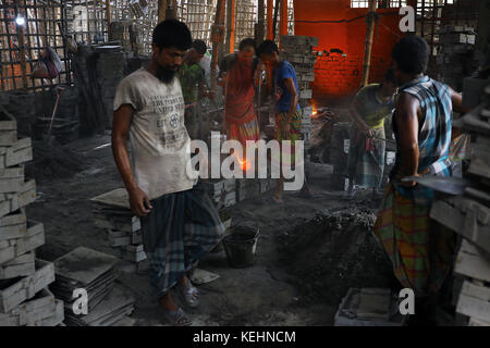 Workers in the steel re-rolling mills work without proper safety gear or tools. In these mills iron is forged in 1200 + to 1300+ Celsius. In such a he Stock Photo