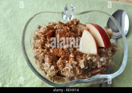 Healthy breakfast - oat flakes with grated apple and mashed banana sprinkled with cinnamon Stock Photo