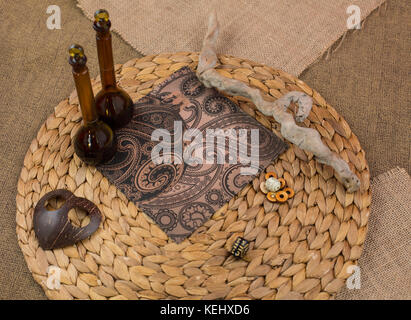 Sewing textile or cloth. Gold scissors pin cushion, and natural white fabric. Work table of a tailor. Shallow depth of field, Focus on scissors. Stock Photo