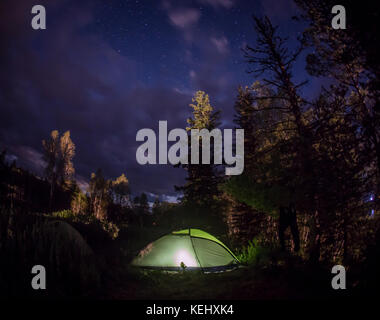 Glowing tent in the mountains under a starry sky Stock Photo - Alamy
