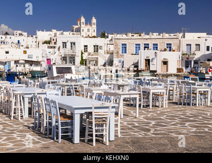 Tables and chairs along the pretty waterfront of Naoussa Town, Paros, Cyclades, Greece Stock Photo