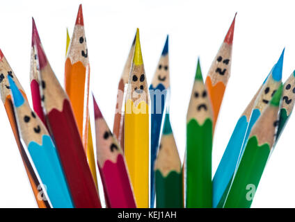 A macro shot of some coloured pencils with faces drawn on them. Stock Photo
