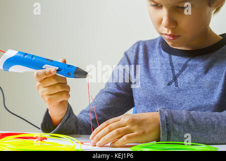 Child creating with 3d printing pen Stock Photo - Alamy