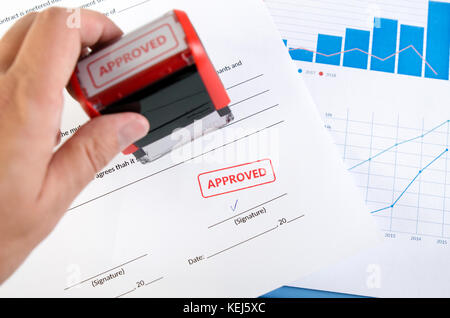 Automatic stamp on the contract document. Approved agreement. approve permit paperwork document automatic stamp authority agreement concept Stock Photo