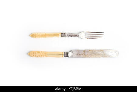 Set of vintage dinnerware. Knife and fork with bone handles on a white background. Top view Stock Photo