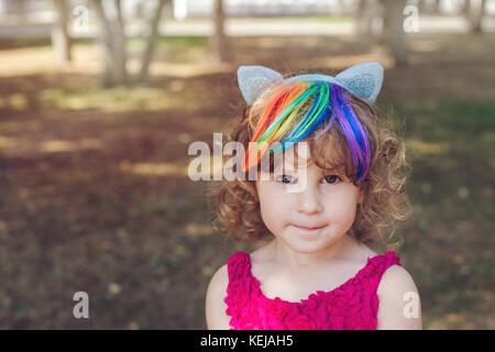 Young girl with ears in park Stock Photo