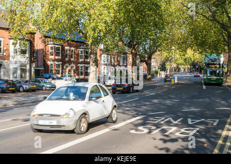 Tree lined main road in a city. Lenton, Nottingham, England, UK Stock Photo