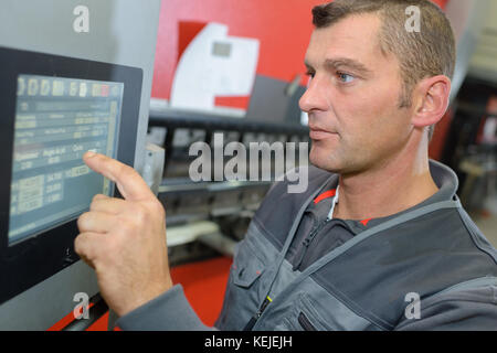 Worker using touch screen technology Stock Photo