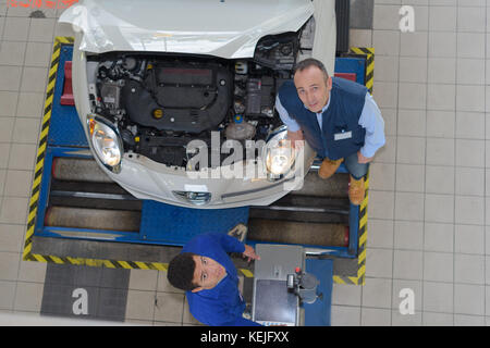 top view of a mechanic and apprentice working Stock Photo