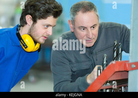 male engineer in factory using milling machine Stock Photo