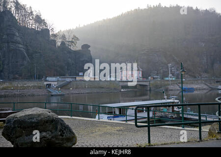 Scenic view on Czech Hrensko village on Elbe river bank from ferry Schona near train station on German side in early winter morning. Stock Photo