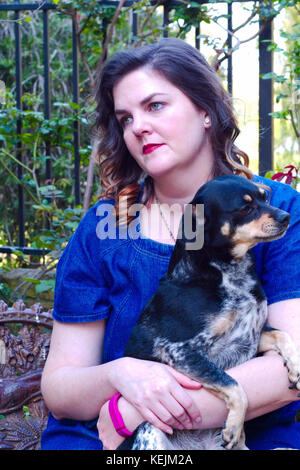 Lady Holding Dog Stock Photo