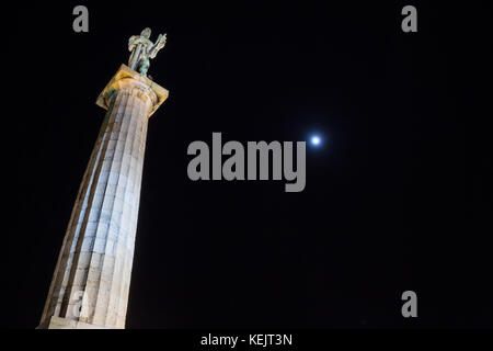 Statue of the Victor (Pobednik, or Viktor in Serbian) on Kalemegdan fortress in belgrade, Serbia, taken at night, the moon being visible in the backgr Stock Photo