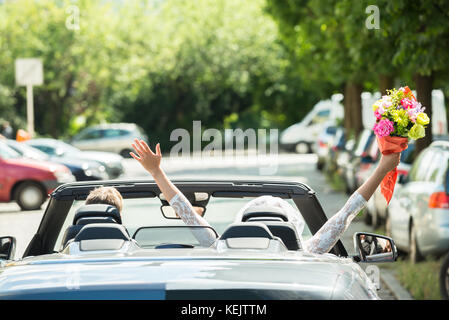 Newlyweds Young Couple Traveling In The Car Stock Photo