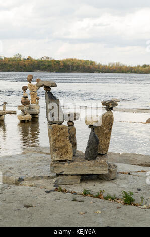 2017 Inukshuks: For more then 30 years Inukshuks, or balanced rock sculptures, have been at Remics Rapids on the Ottawa River just west of downtown Ot Stock Photo